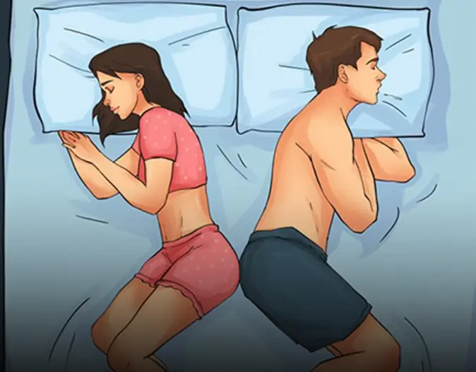 Couple assis dos à dos, symbolisant la distance dans la relation